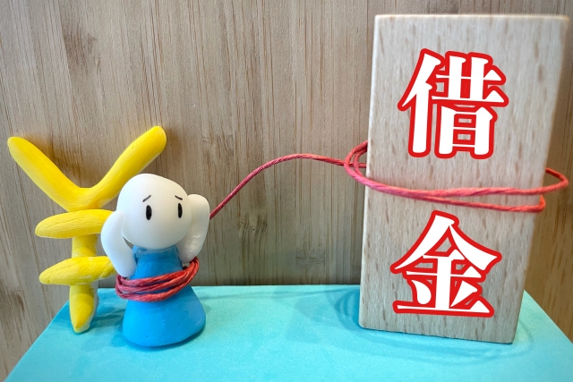 お金を手に頭を抱える。富士見市で債務整理の無料相談ができます